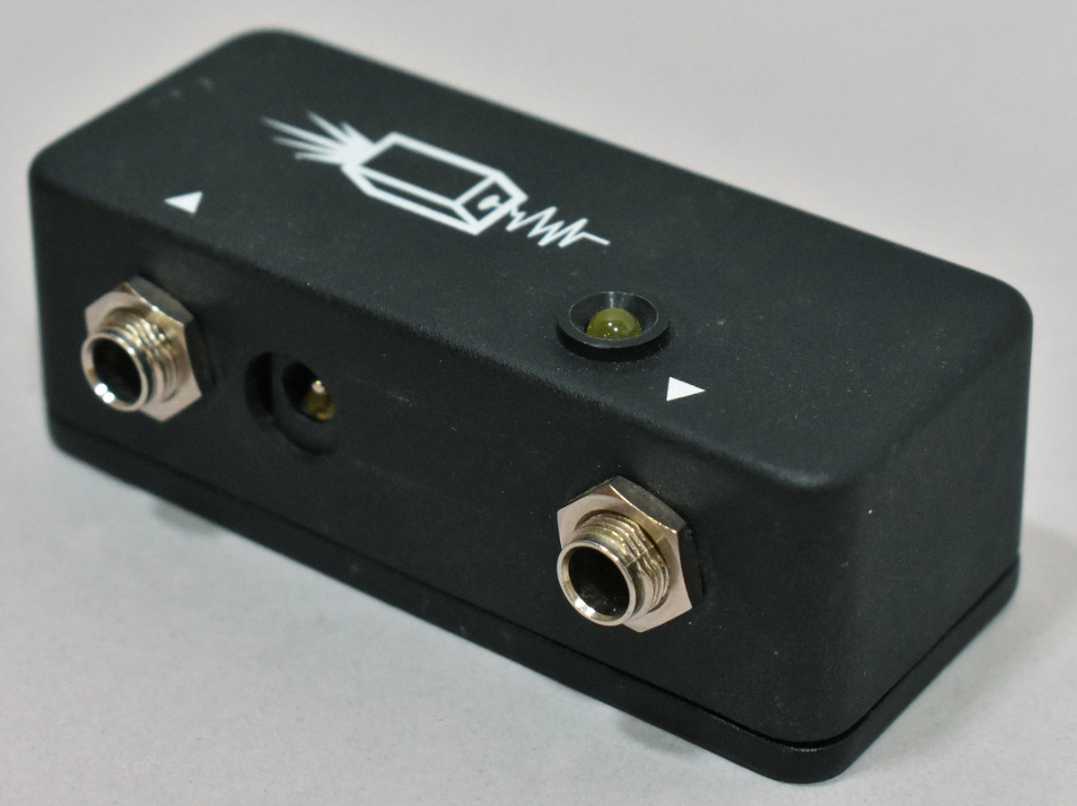 A black JHS Little Black Buffer pedal with two input jacks, a power input, a green LED, and a white logo.