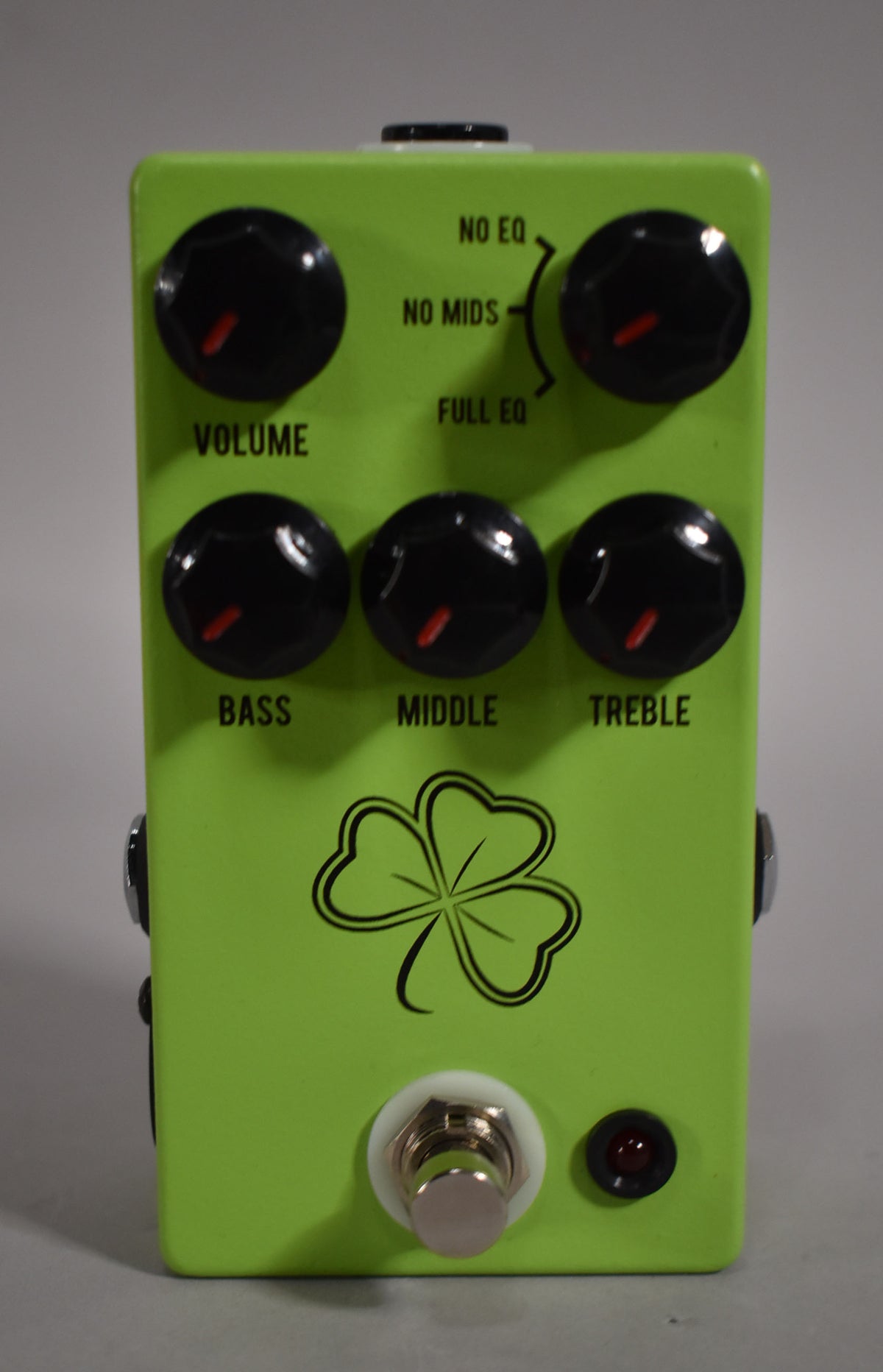Front view of a bright lime green pedal with six black knobs, a silver footswitch, and a red indicator light.