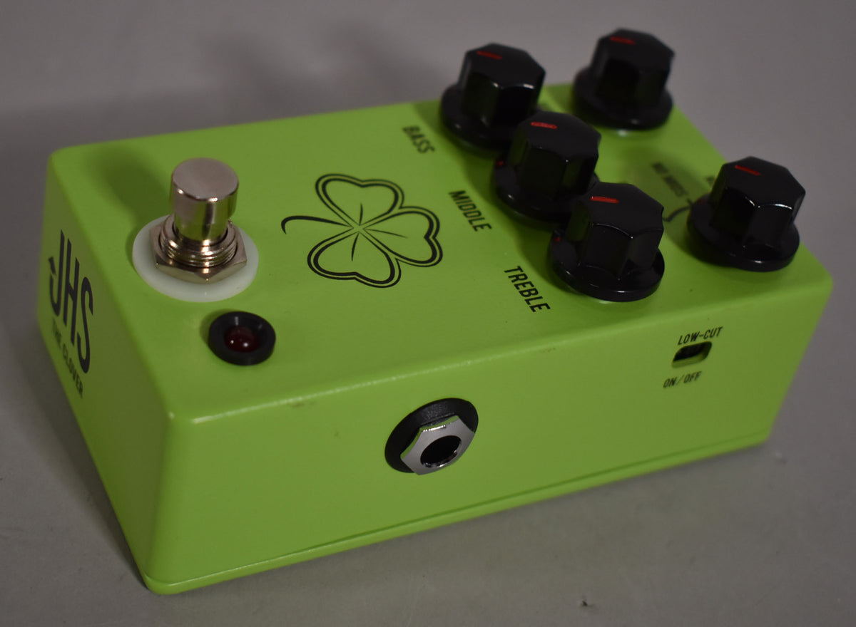 The bright green pedal is angled from the left, showing a chrome footswitch, five black control knobs, and a 1/4-inch input jack.