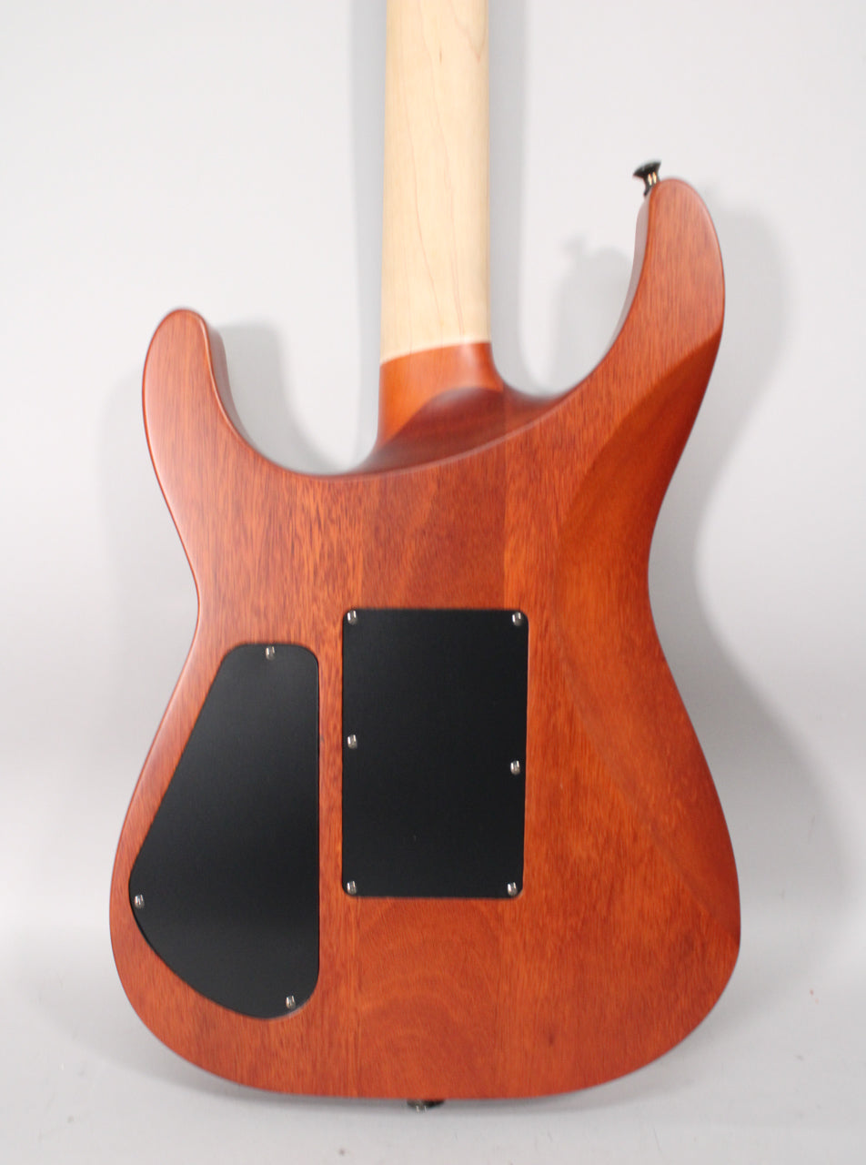 Back of a reddish-brown guitar body with two black control plates, a light wood neck, and a strap button.