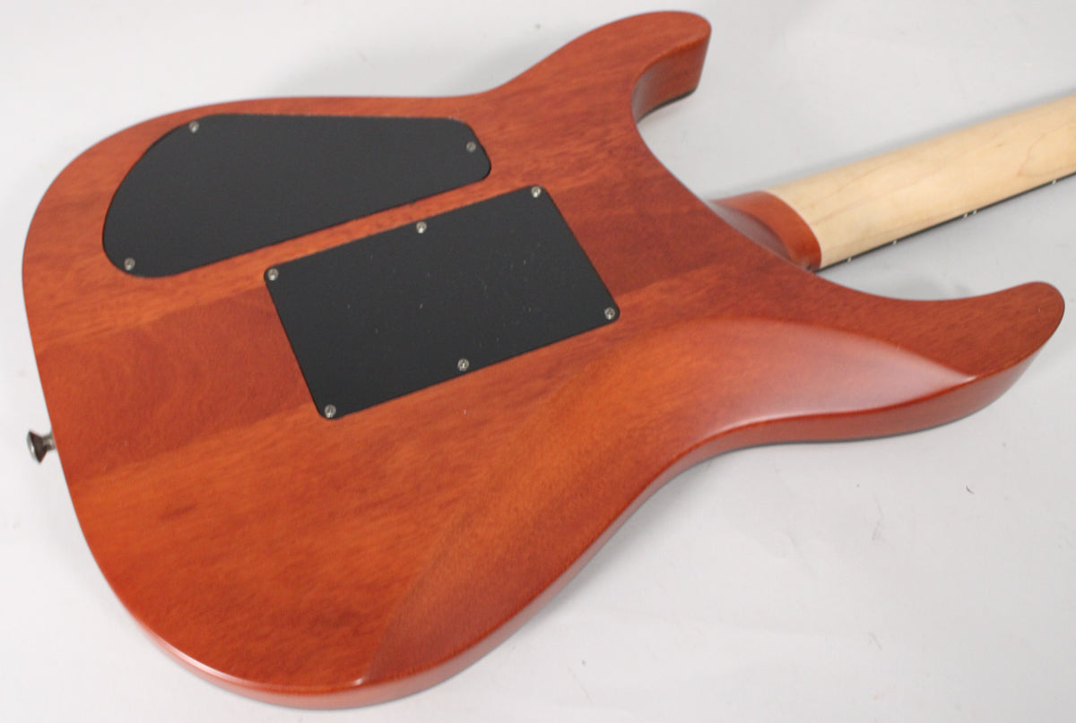 The back of a reddish-brown electric guitar, showing two black control cavity covers and a light-colored neck.