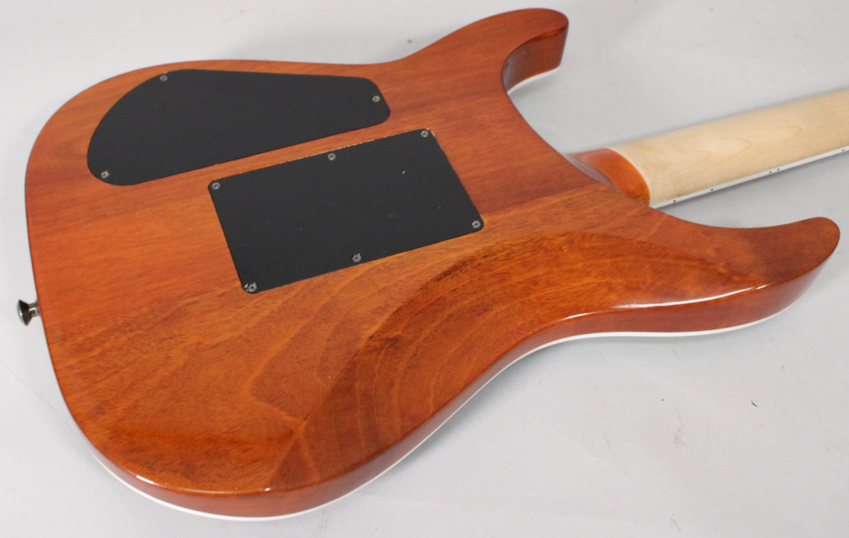 The guitar's mahogany back, with two black control cavity covers, and a light maple neck are visible from a low angle.