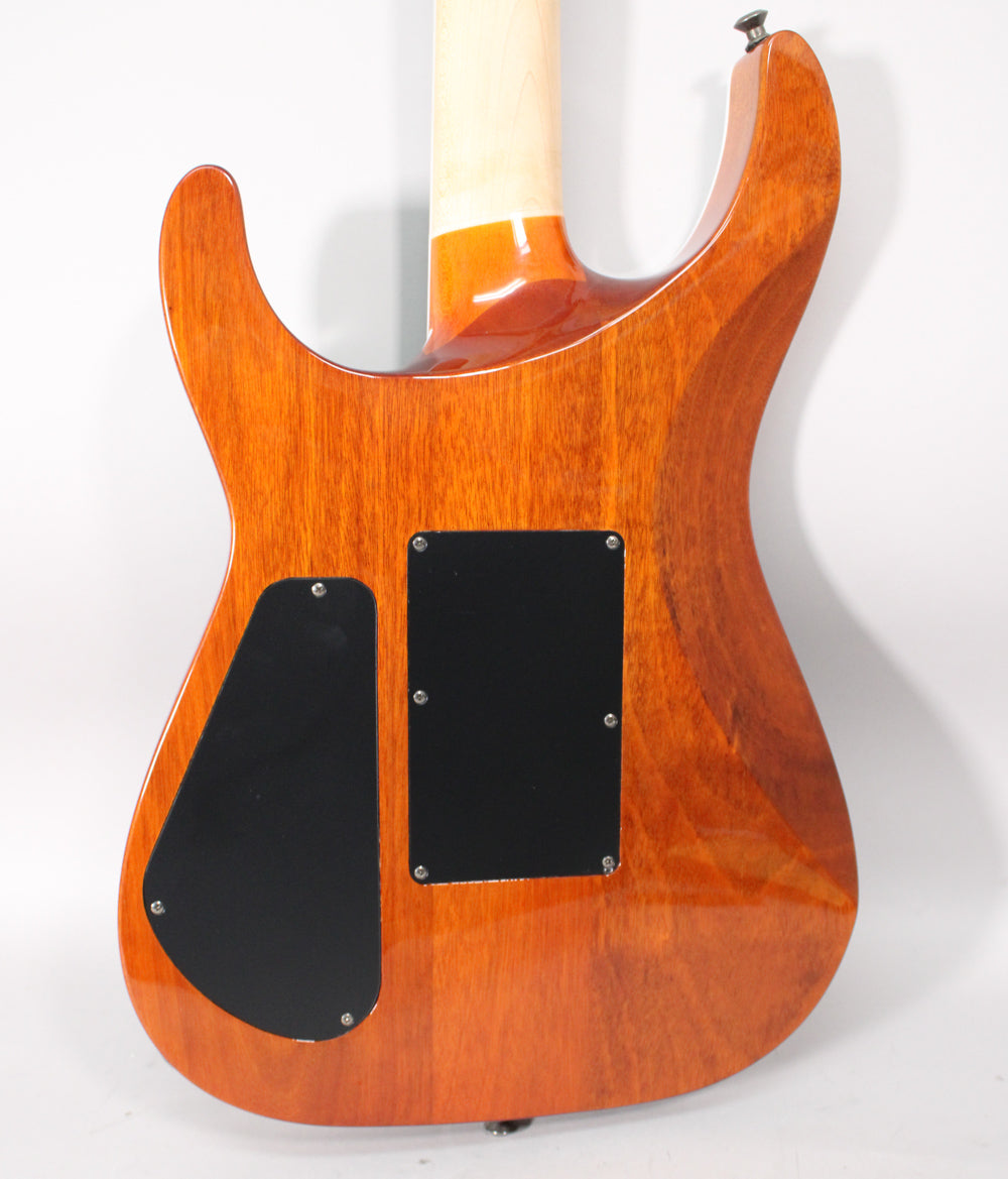 The guitar's back is a glossy reddish-brown with visible wood grain, featuring two black control cavity covers.