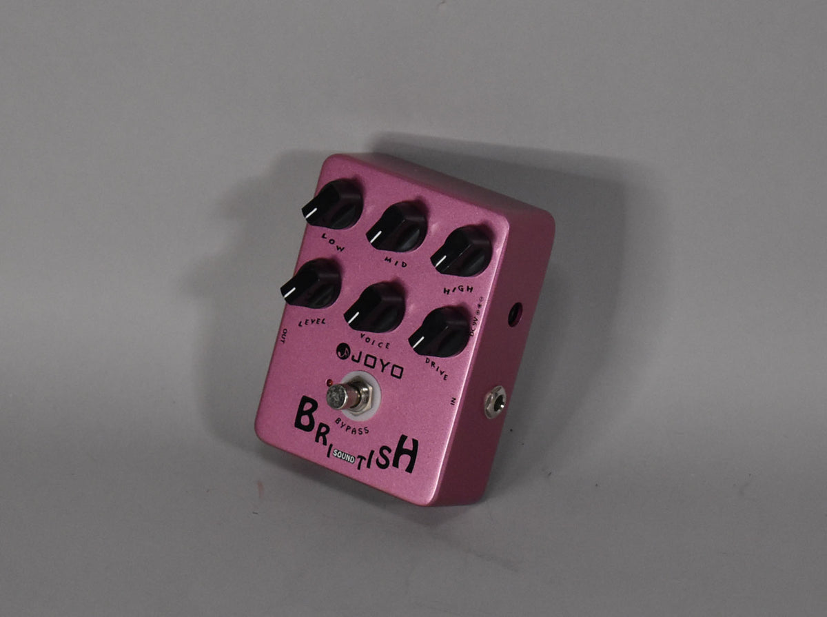 A fuchsia metallic effects pedal, angled from the top right, with six black control knobs and a chrome bypass footswitch.