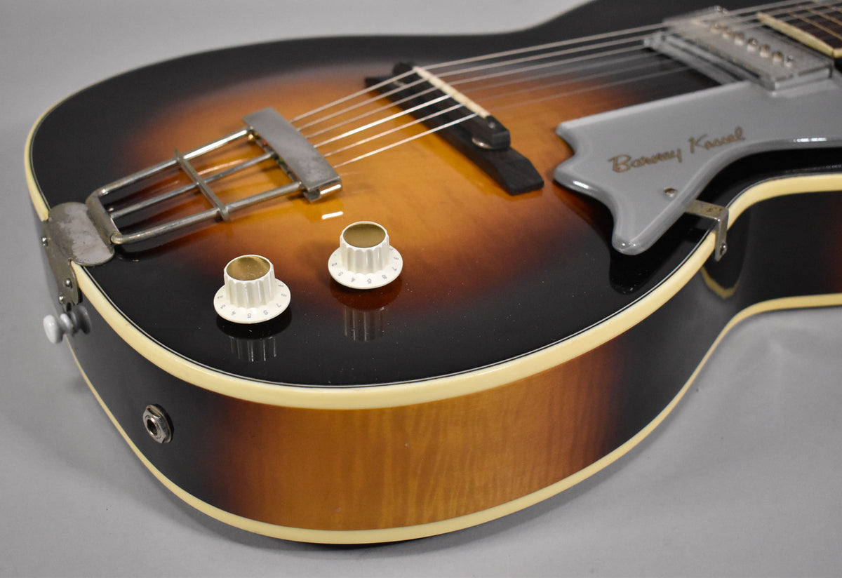 Close-up of the sunburst body, showing the lower bout, output jack, two white control knobs, and the grey pickguard with "Barney Kessel" in script.