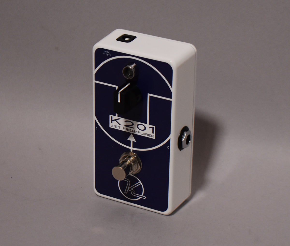White pedal with a dark blue faceplate, featuring a single footswitch, a small black knob, and a 1/4" jack on the right side.