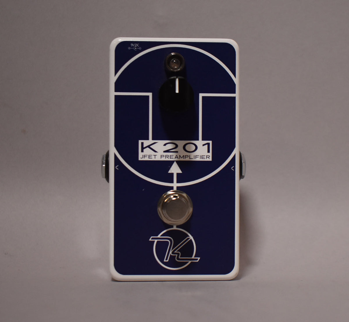 Front view of a dark blue pedal with white graphics, a black knob, and a silver footswitch.