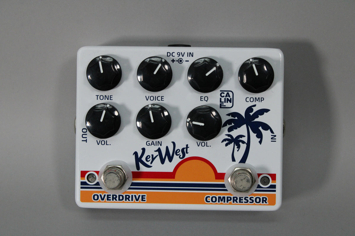 White Caline Key West Compressor/Overdrive pedal with 7 black knobs, 2 footswitches, and a palm tree graphic.