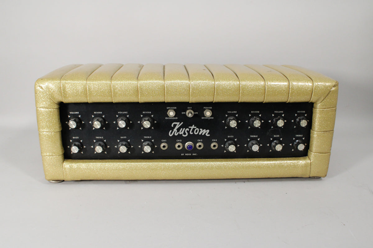 Front view of a gold sparkle PA head with a black control panel, many knobs, and four input jacks.