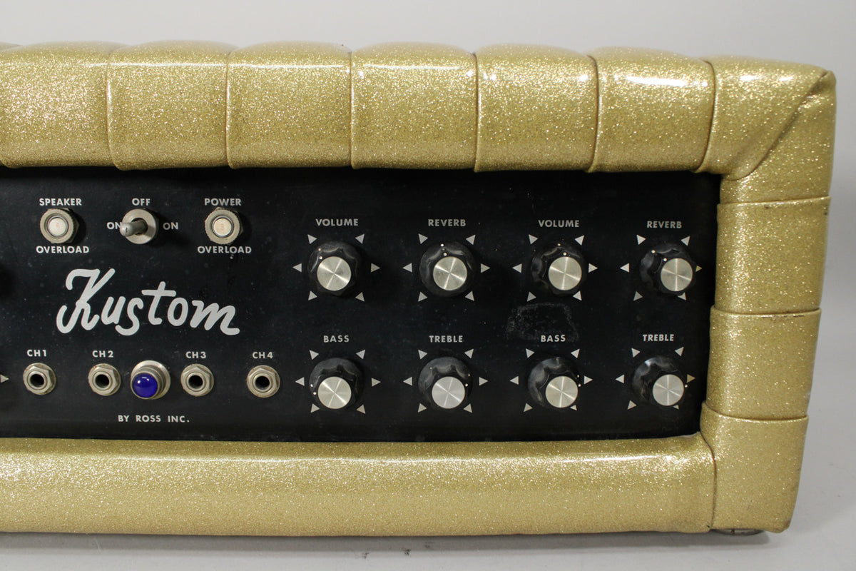 Close-up of the gold sparkle PA head's black control panel, showing multiple knobs, switches, and four input jacks.