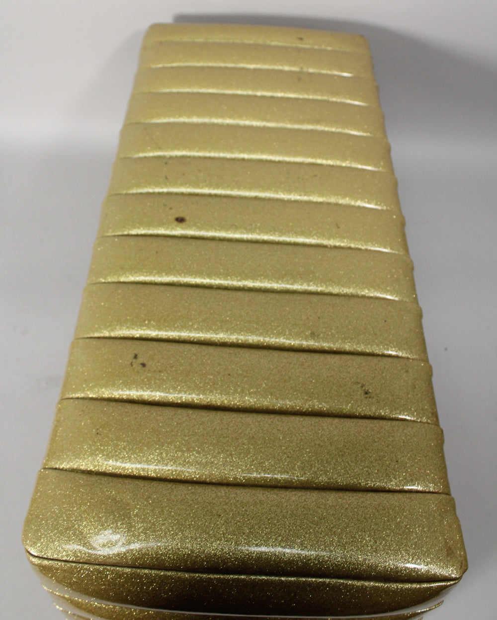 Top-down view of the gold sparkle PA head, showing its ribbed, padded finish with some dark scuffs and wear.