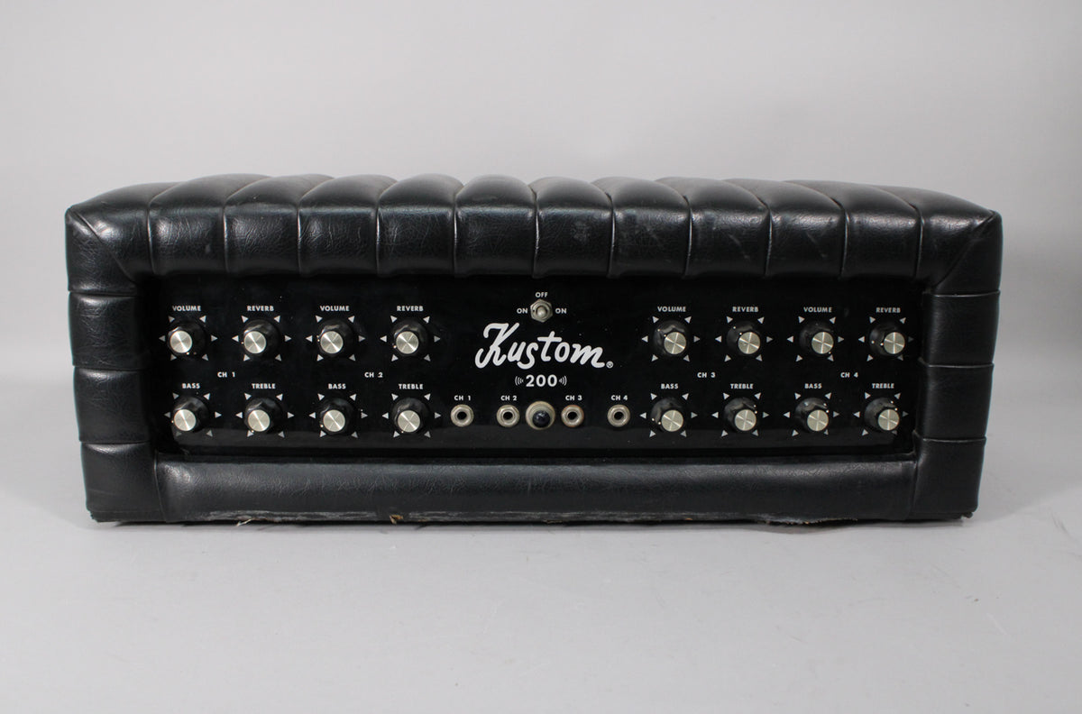 Front view of a black Kustom K200-5 amp head with a tufted vinyl top and a black control panel featuring 16 silver-capped knobs and 4 input jacks.