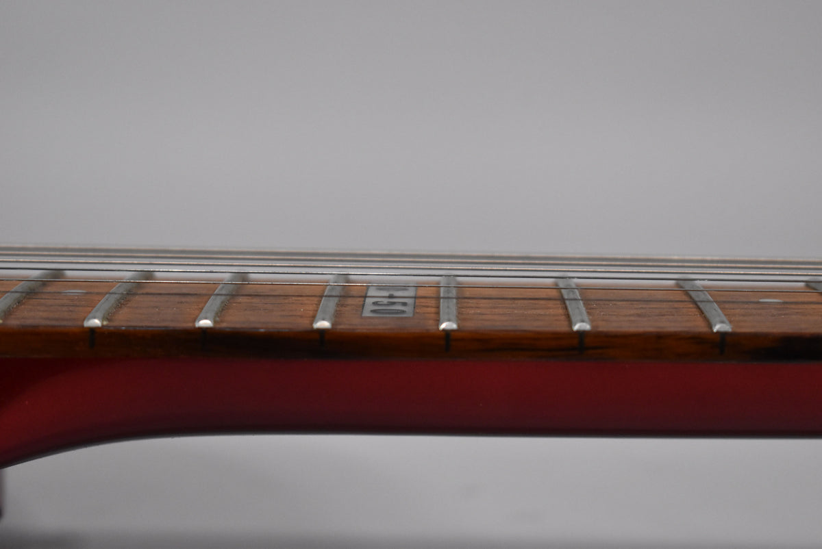Close-up of the guitar's fretboard, showing the dark wood, silver frets, and the "EC-50" inlay at the 12th fret.