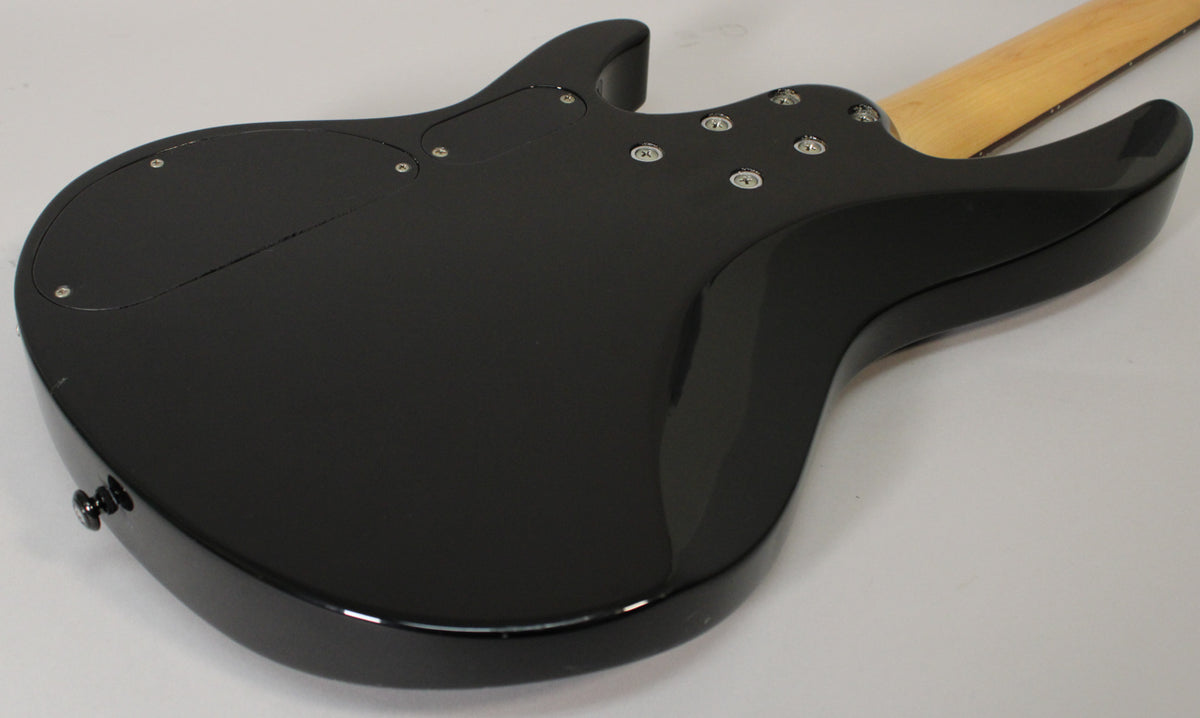 The black gloss bass guitar's back shows a control cavity cover, a bolt-on neck joint, and a few light scratches.