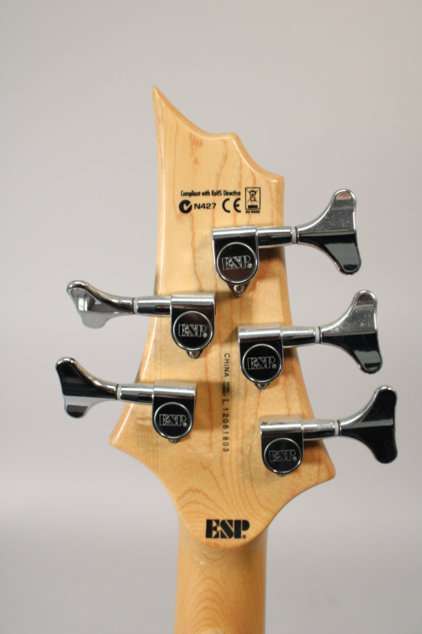 Rear view of the bass headstock, showing five chrome tuning machines on a light wood finish, with some light wear.