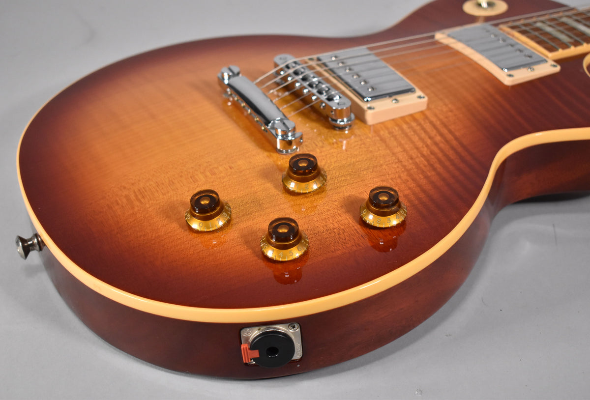 Close-up of the lower body, showing the Heritage Cherry Sunburst finish, four amber speed knobs, and the output jack.