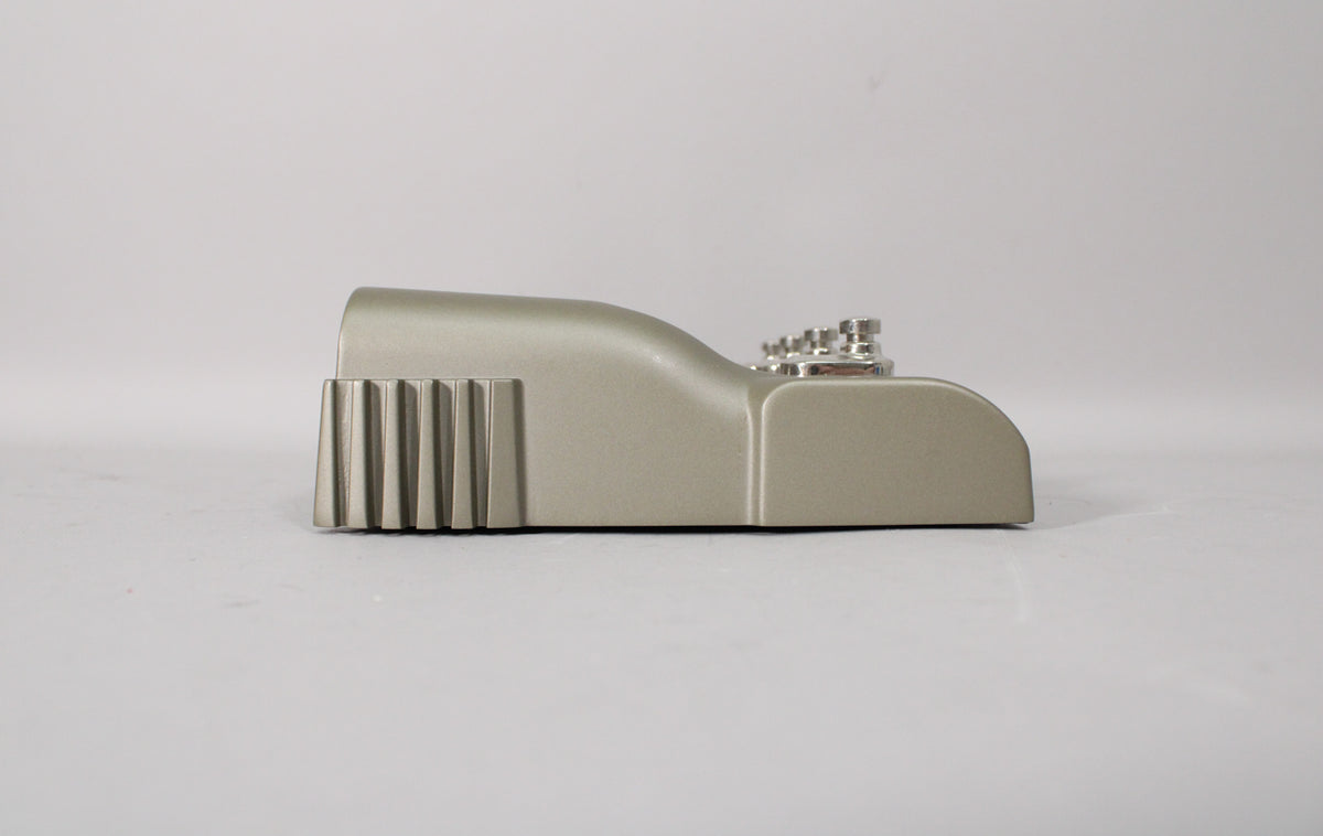 The Line 6 JM4 Looper pedal is shown from the left side, revealing its light gray finish, ribbed left edge, and silver knobs.