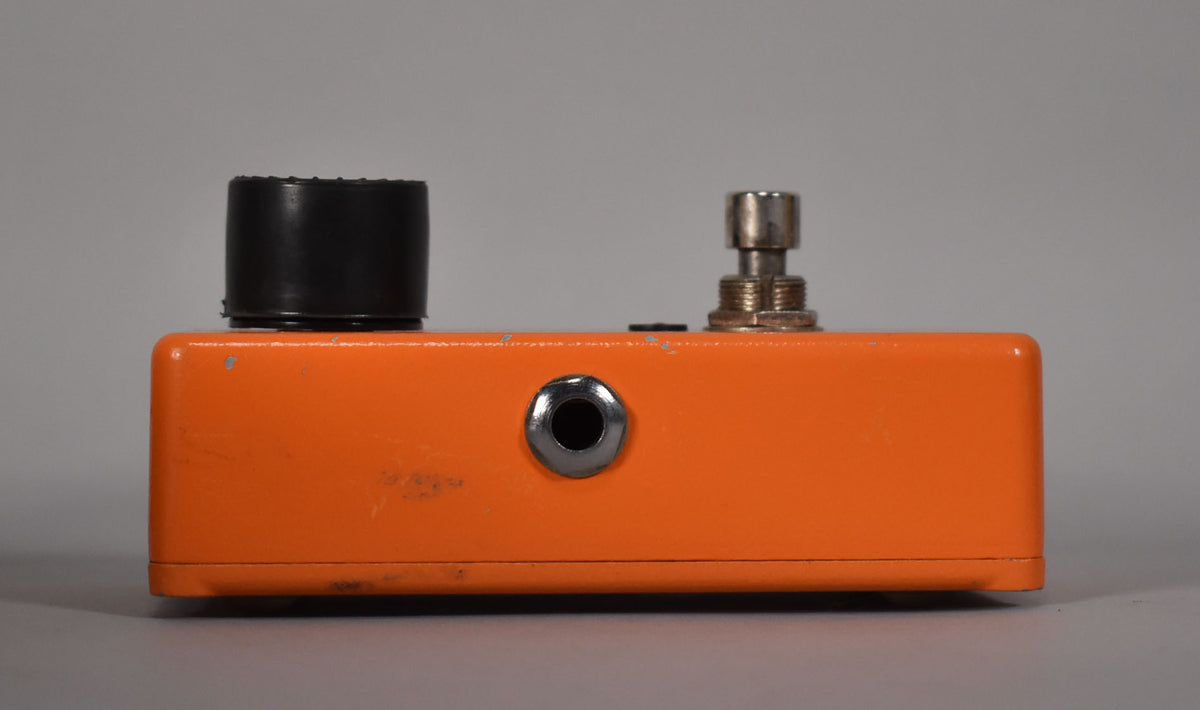 Side view of an orange MXR Phase 90 pedal with a black knob, a silver input jack, and a silver footswitch.