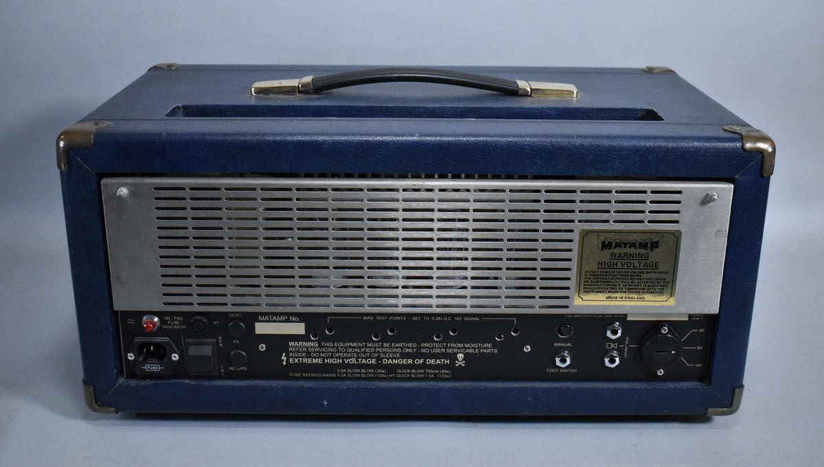 Rear view of a blue rexine amplifier head with a silver metal grille, black handle, and various input/output jacks.