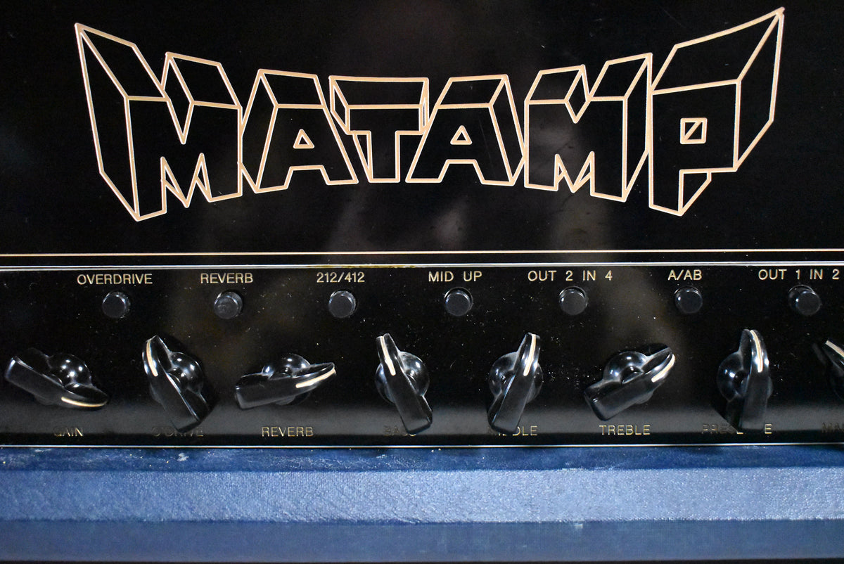 Close-up of the amp's black control panel with gold lettering and black chicken head knobs, showing some light wear on the blue rexine.