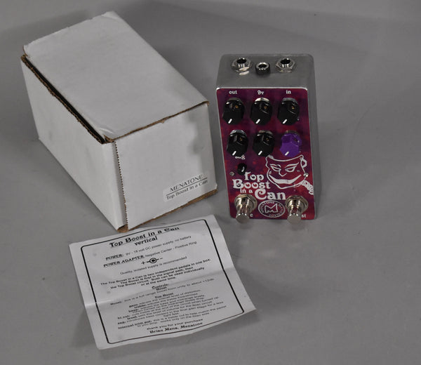 The pedal, box, and manual are angled from above, showing the pedal's purple face with six black knobs and two footswitches.