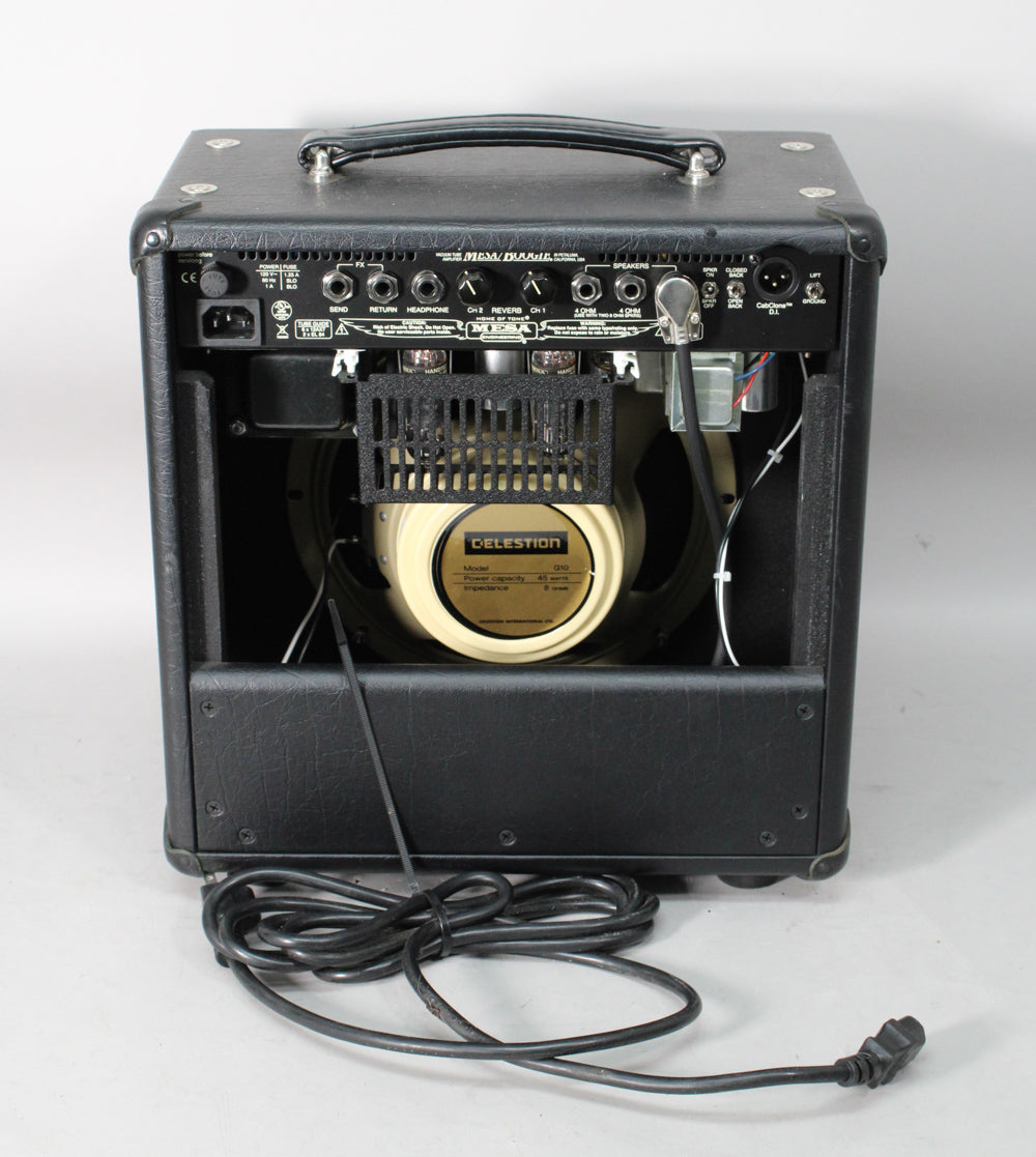 Rear view of a black combo amp, showing the cream Celestion speaker, exposed tubes, and a coiled power cable.