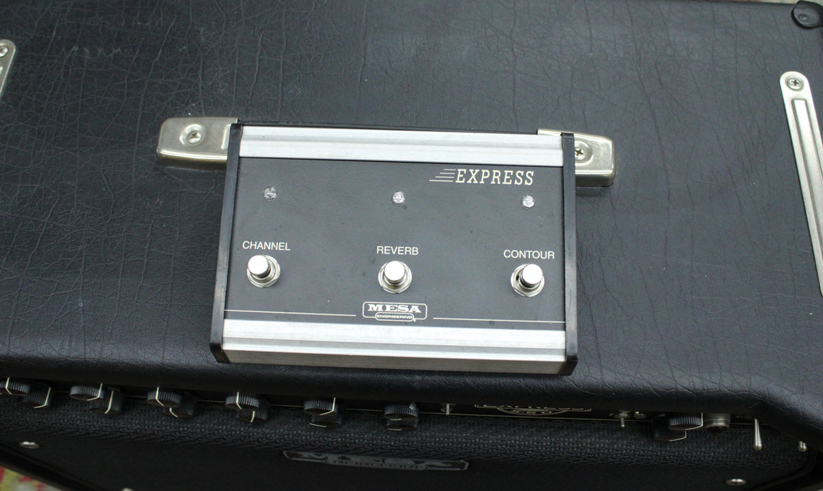 Close-up of the black footswitch with three silver buttons for Channel, Reverb, and Contour, resting on the amp's textured black top.