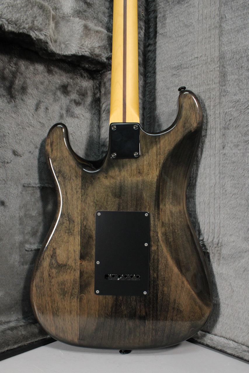 The back of a gray-stained electric guitar with a gloss finish, showing the neck joint, black tremolo cover, and light wood neck.