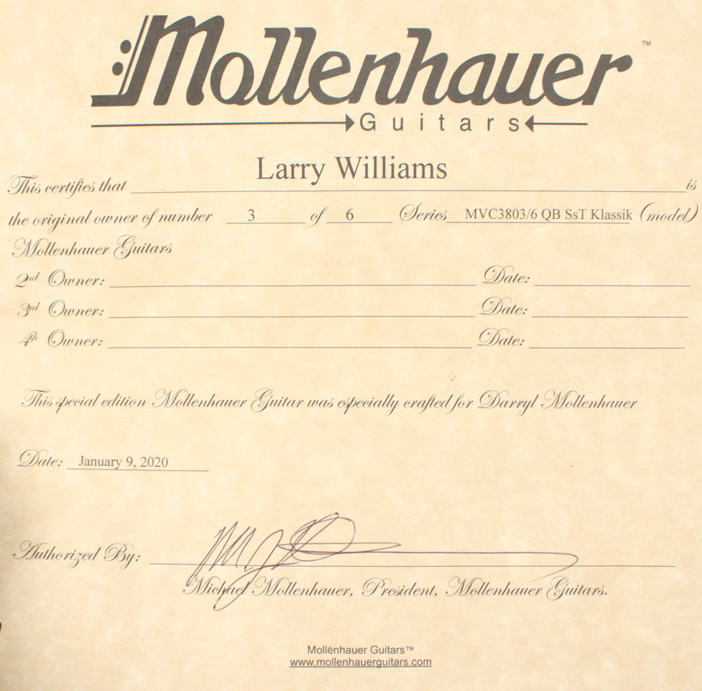 A close-up of a cream-colored certificate with black text and signatures, detailing ownership and model information.
