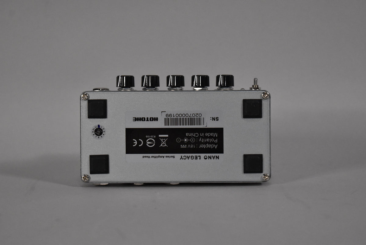 The back of a silver Hotone Nano Legacy Series Amplifier Head with black knobs, a serial number, and product information.