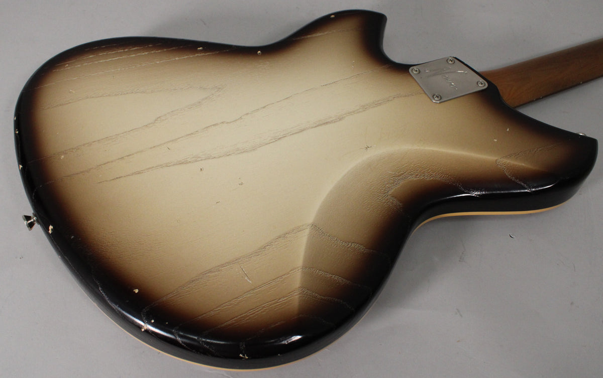 The back of the guitar shows a toasted marshmallow burst finish with heavy checking, dings, and a silver neck plate.
