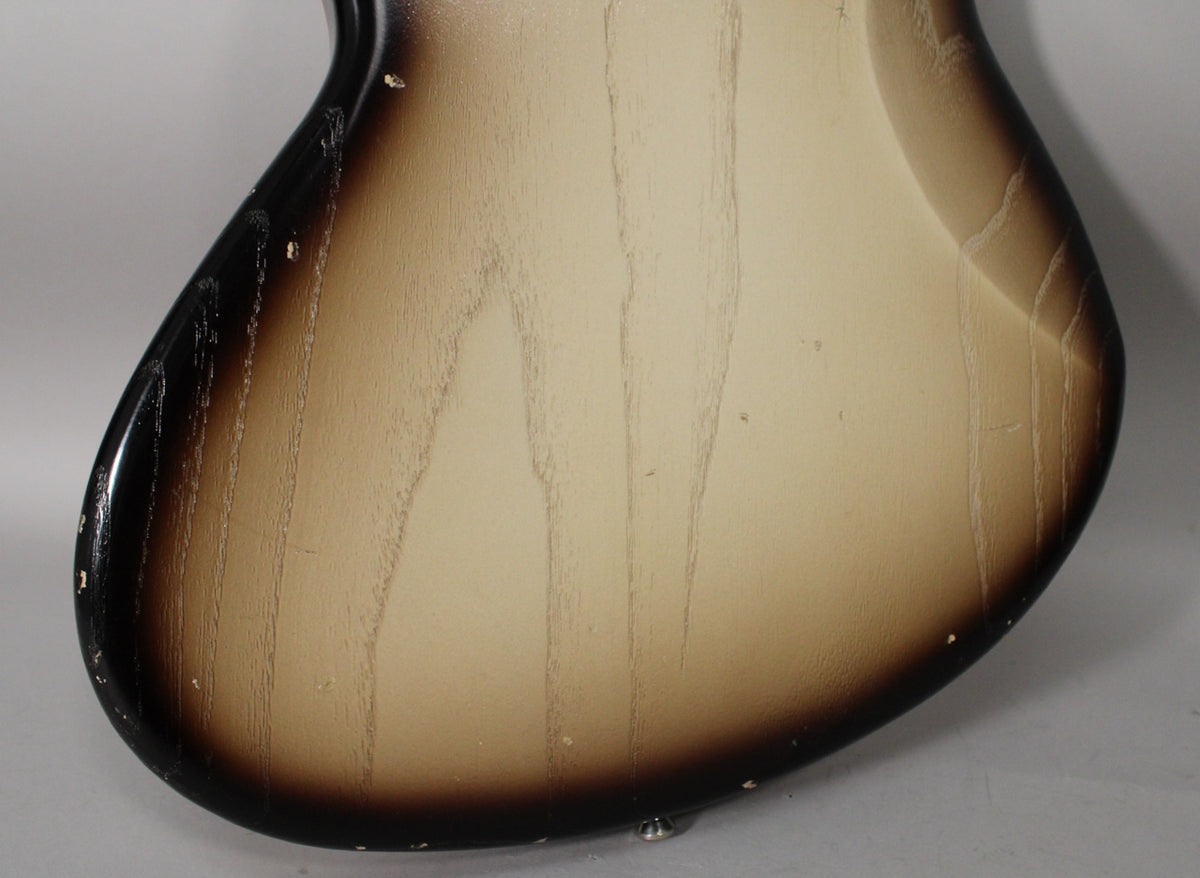 The guitar's lower back shows a toasted marshmallow burst finish with visible wood grain and light aging around the edges.
