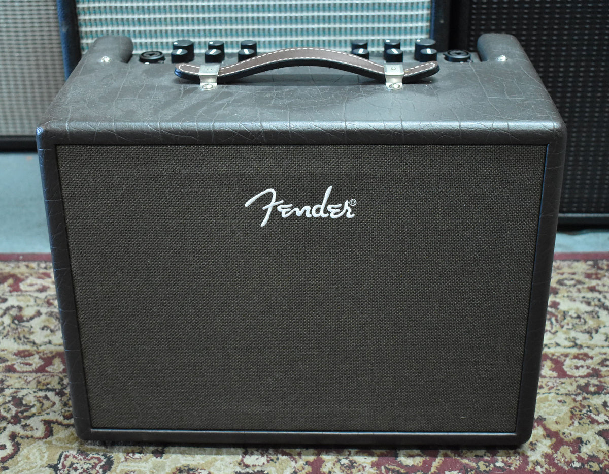 Front view of a dark brown combo amp with a textured finish, dark grille cloth, and a brown leather handle with white stitching.