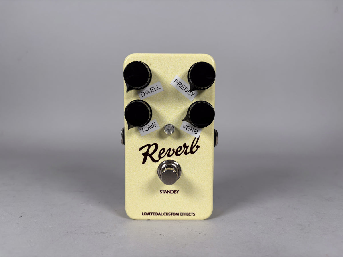 Cream-colored reverb pedal, top-down view, with four black control knobs and a footswitch, all with white labels.