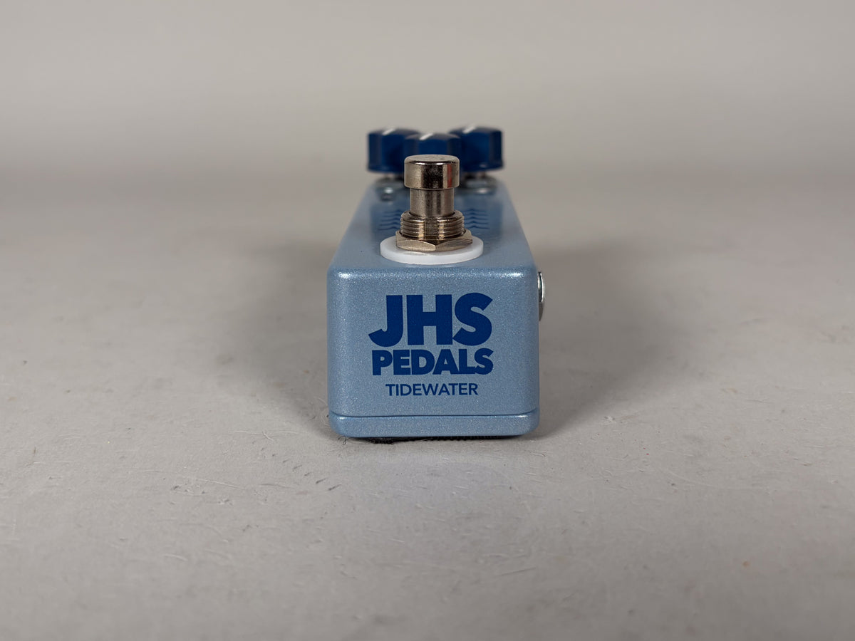 Light blue effect pedal, viewed from the front, with a silver footswitch and two dark blue knobs visible on top.