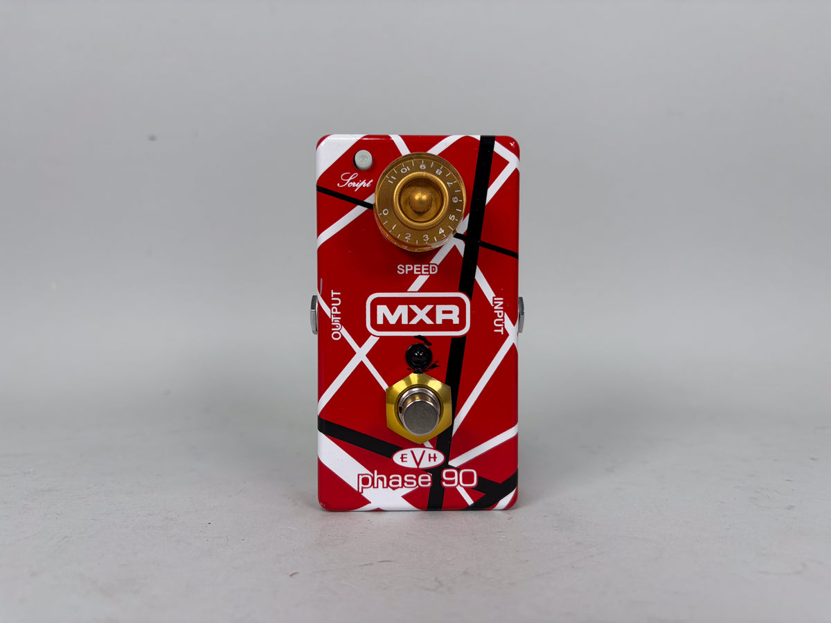 A red guitar pedal with white and black stripes, featuring a gold speed knob and a gold footswitch.