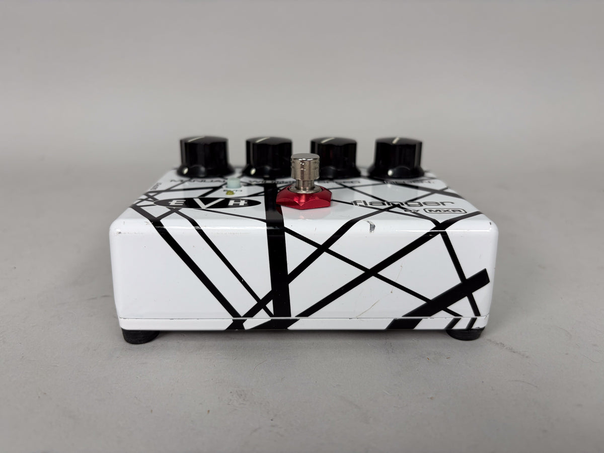White guitar pedal with black stripes, four black knobs, and a red-topped footswitch, viewed from the front.