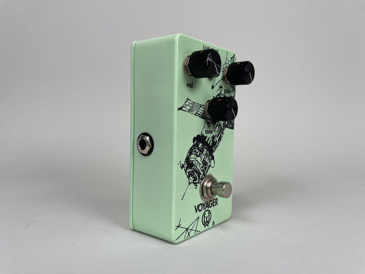 Light green pedal, angled right, showing the input jack, three black knobs, and a footswitch with a satellite graphic.