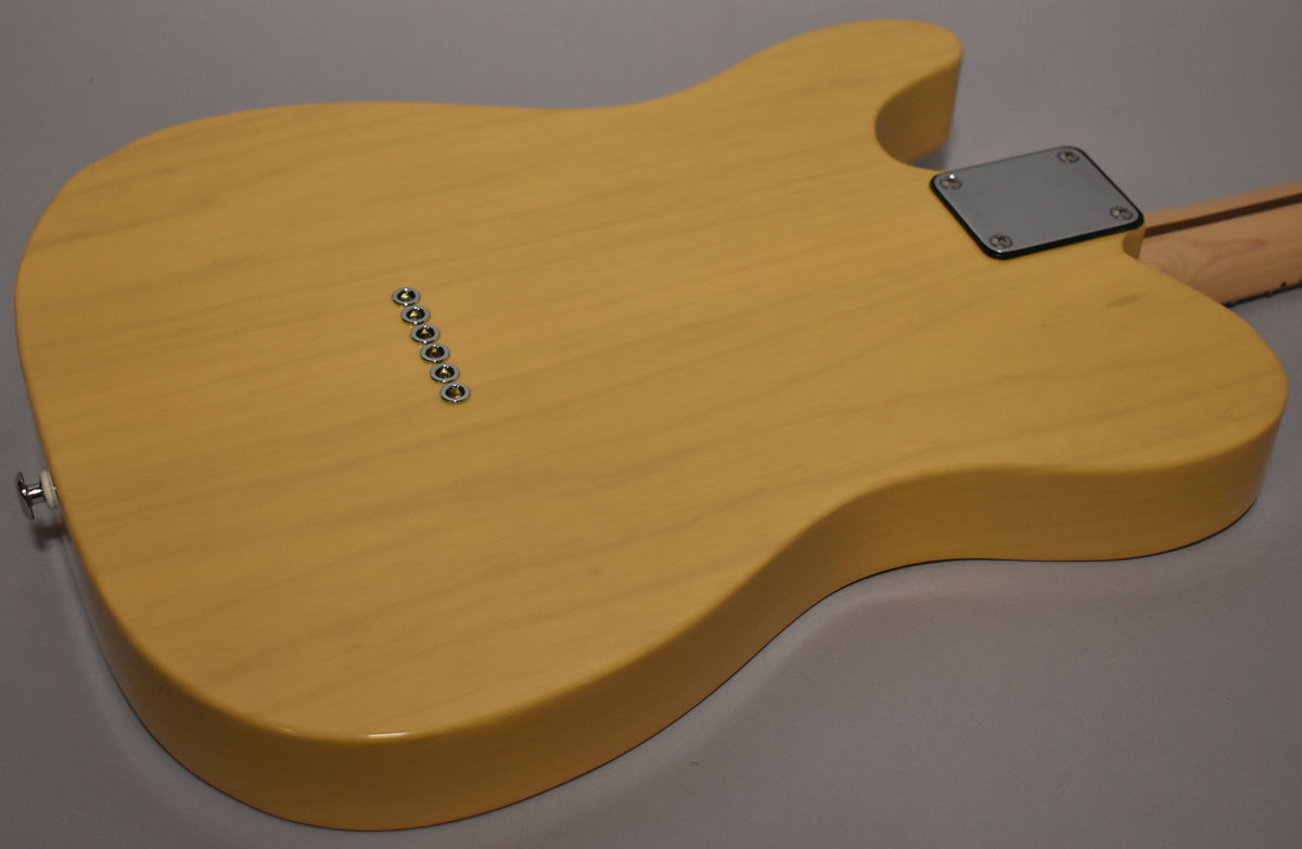 The butterscotch guitar's back shows string-through-body ferrules, a chrome neck plate, and a strap button, with light wood grain.