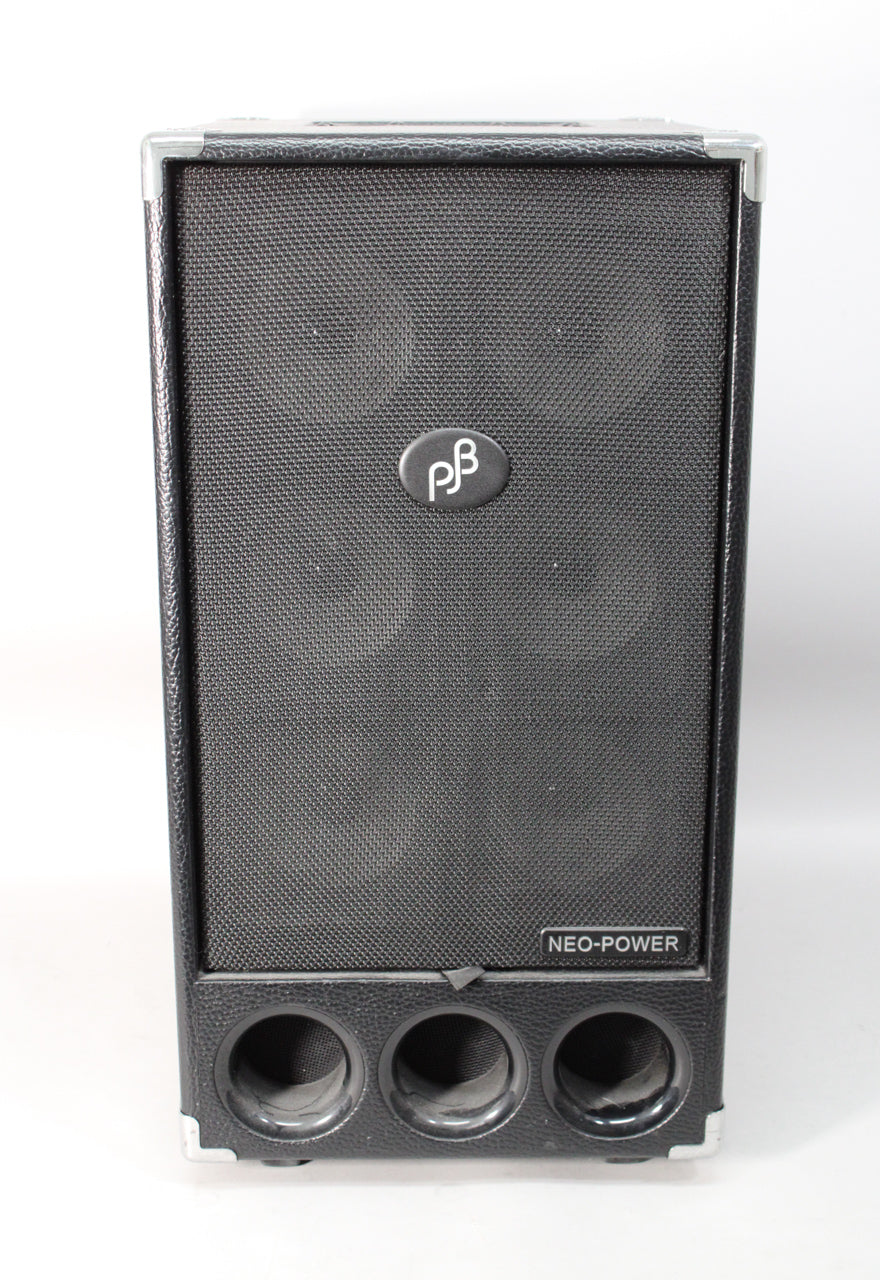 Black speaker cabinet with a textured finish, metal corner protectors, a large speaker grille, and three circular ports below.