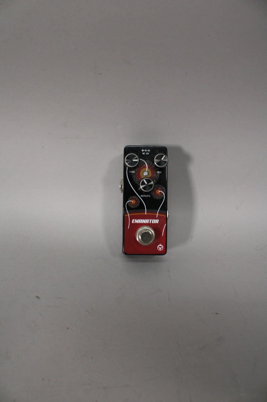 A black and red delay pedal with three black control knobs, a silver footswitch, and a cosmic-themed graphic.