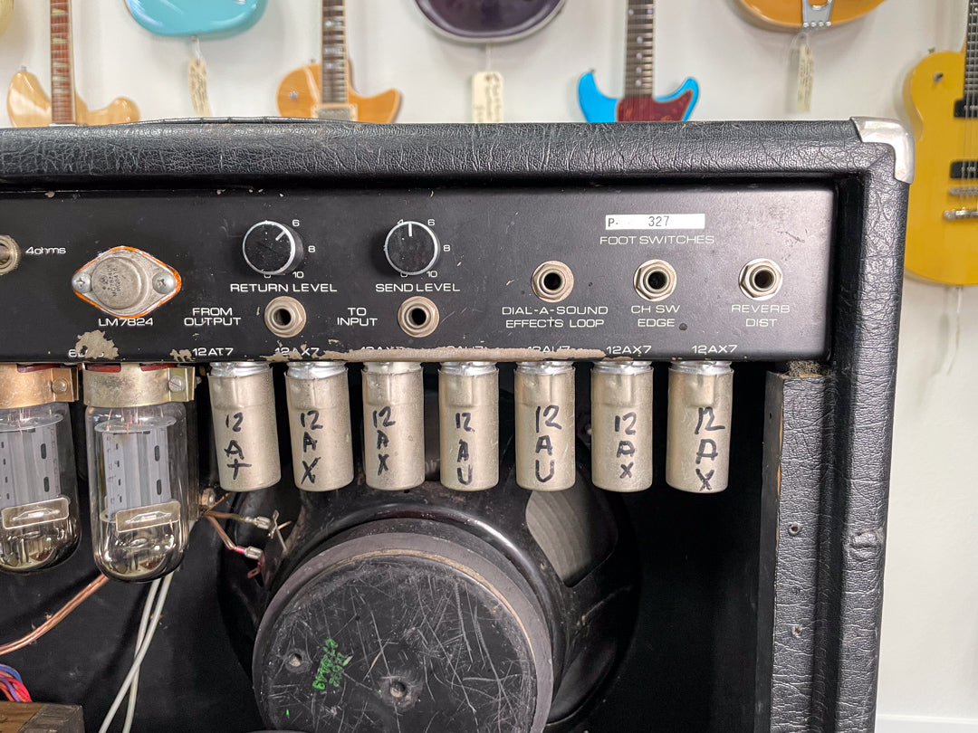 Close-up of the amp's rear panel, showing tubes, effects loop, and footswitch jacks, with visible wear and handwritten tube labels.