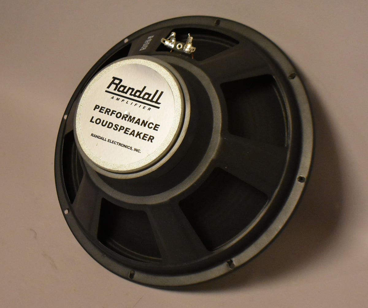 A black speaker is angled, showing its textured cone, silver dust cap, and two silver terminals at the top.