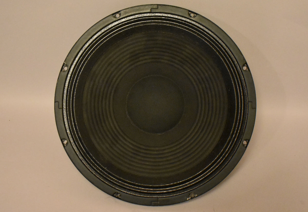 Front view of a black speaker with a ribbed cone, showing eight mounting holes around the outer edge of the frame.