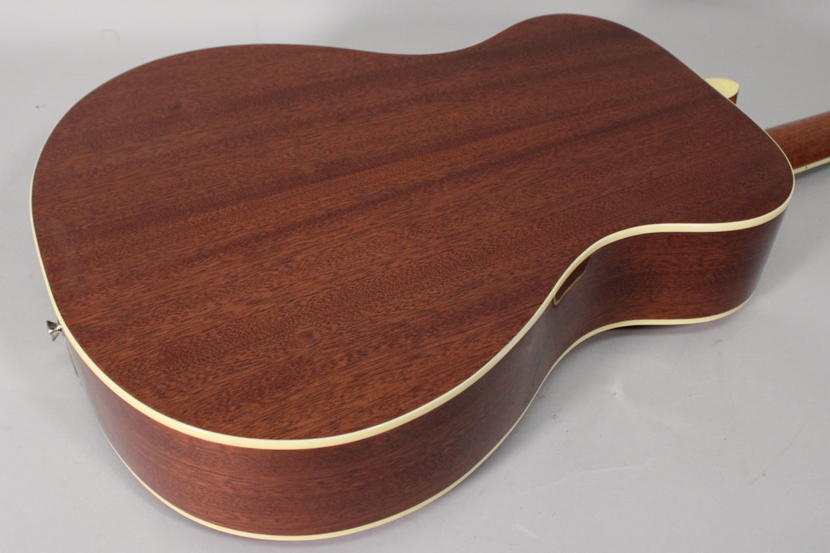 The back of a cherry sunburst resonator guitar, showing the dark wood grain and light binding around the body.