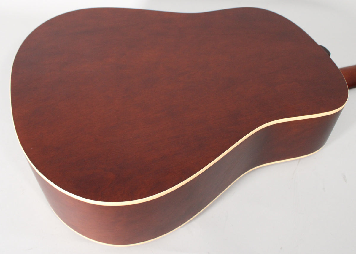 The back of a reddish-brown acoustic guitar, showing the lower bout and waist with light binding, angled from the upper left.