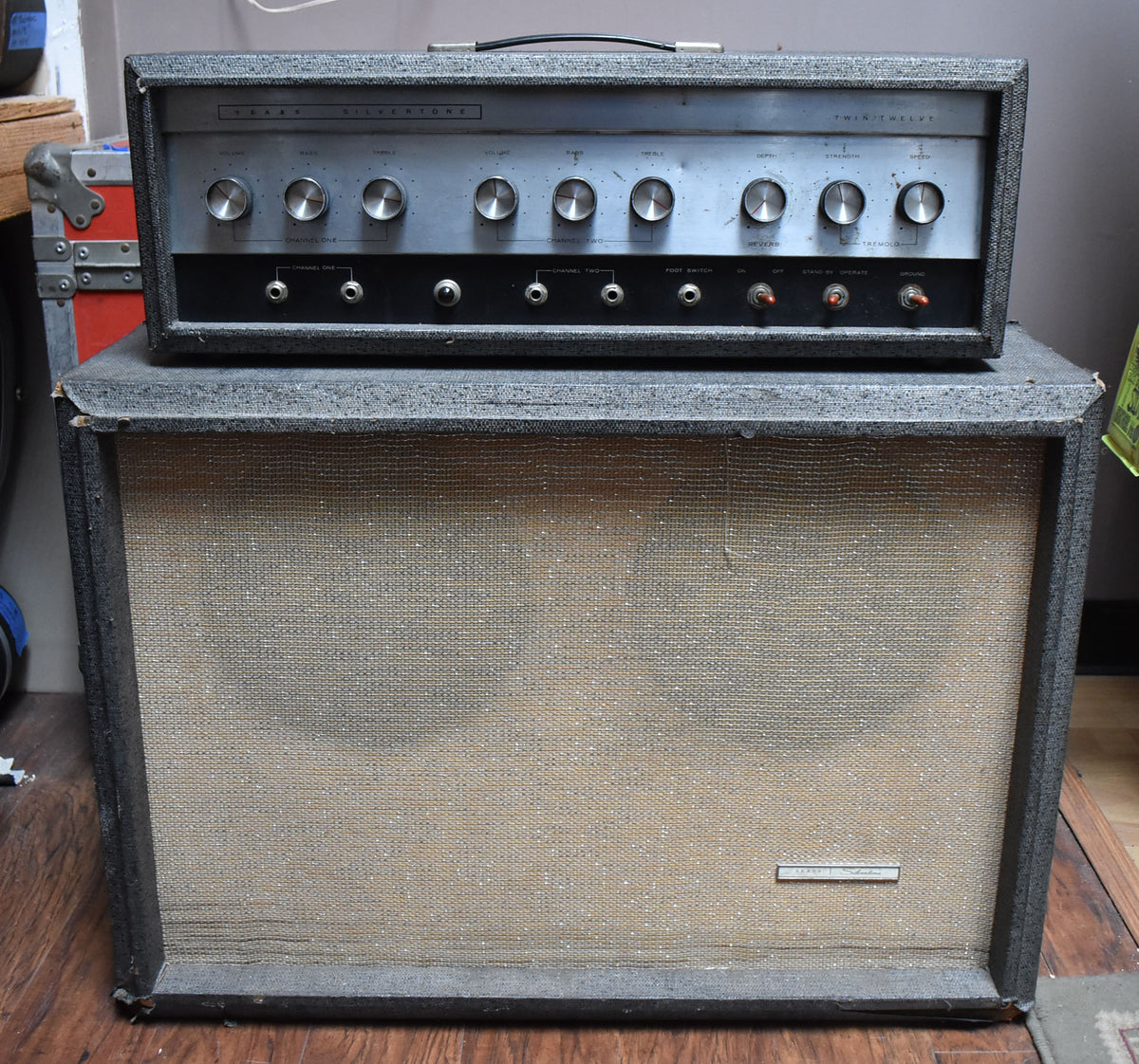 Full front view of a vintage gray tweed amp head with a silver control panel and matching 2x12 cabinet with a tan grille cloth.