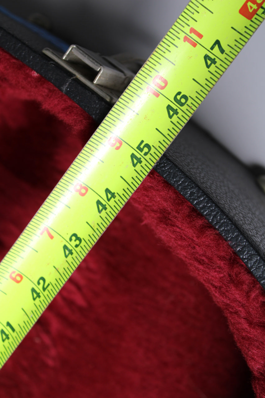 A close-up of the case's black textured exterior and plush red interior, with a yellow measuring tape showing 41 to 47 inches.