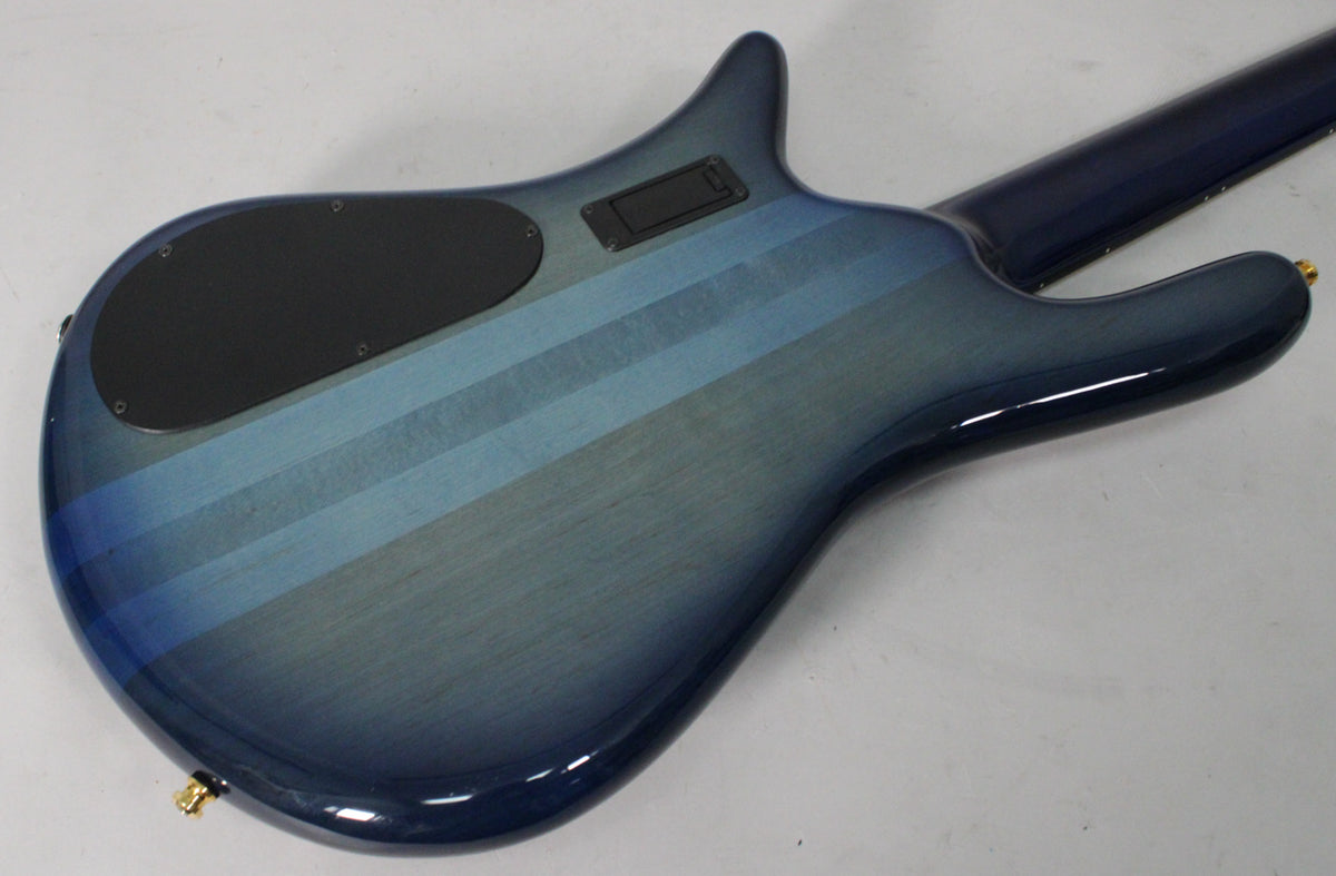 The bass guitar's back, angled from the lower bout, shows a blue fade gloss finish with horizontal stripes and a black control plate.