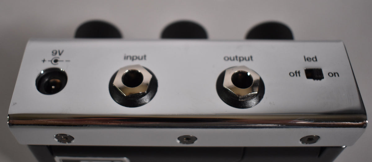 The chrome effect pedal's top edge shows a 9V power input, input/output jacks, and an LED on/off switch.